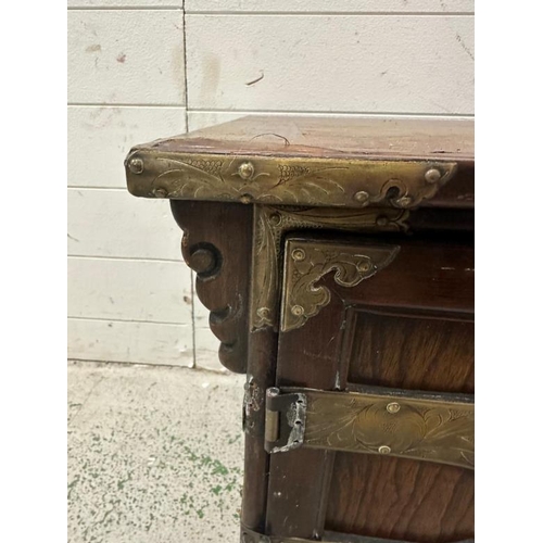 162 - A Korean style hardwood cabinet with brass hinges and fittings the cupboard opening to a single draw... 