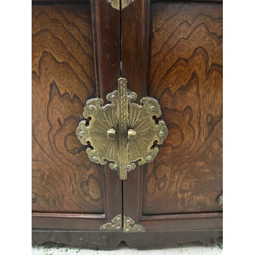 162 - A Korean style hardwood cabinet with brass hinges and fittings the cupboard opening to a single draw... 