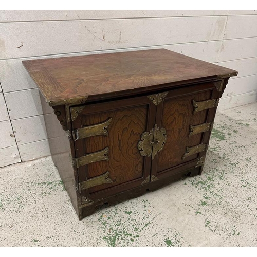 162 - A Korean style hardwood cabinet with brass hinges and fittings the cupboard opening to a single draw... 