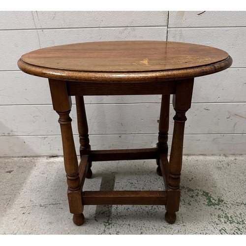 165 - A vintage light oak oval side table (H46cm W51cm D35cm)