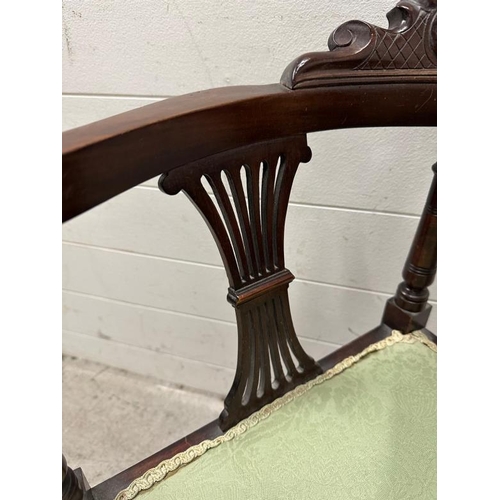 169 - An Edwardian mahogany corner chair on turned legs with green upholstered seat