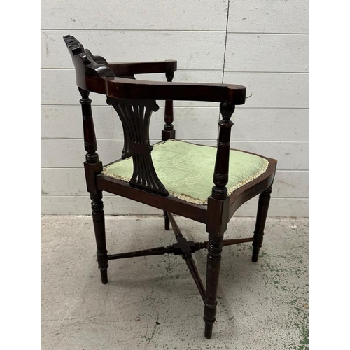 169 - An Edwardian mahogany corner chair on turned legs with green upholstered seat