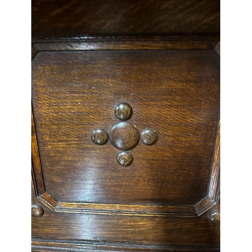 172 - An oak Jacobean style heavily carved court cupboard with three central drawers flanked by cupboards ... 