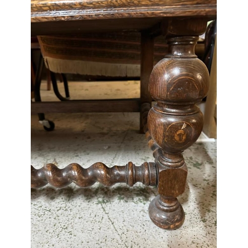 172 - An oak Jacobean style heavily carved court cupboard with three central drawers flanked by cupboards ... 