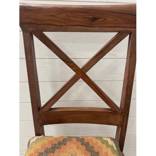 174 - A set of four cross back hardwood dining chairs