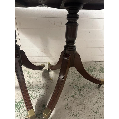 176 - A mahogany extendable dining table on splayed legs and brass castors. 127x97. leaf 57