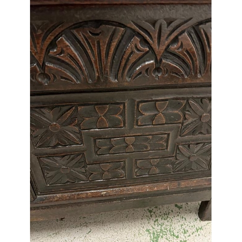 177 - A heavily carved oak coffer with hinged lid opening to storage and internal candle box 127 L x 54 d ... 