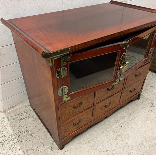 193 - An oriental table cabinet, lacquered and metal furniture