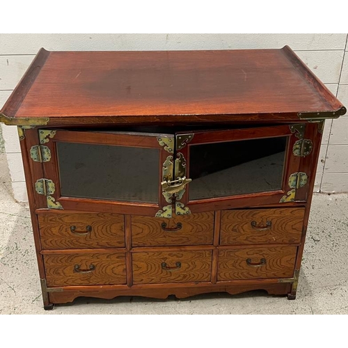 193 - An oriental table cabinet, lacquered and metal furniture