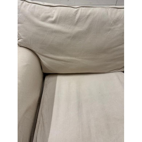 202 - A cream two seater sofa with removable covers