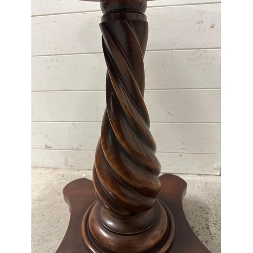 205 - A mahogany pedestal side table on spiralized turned column and four bun feet (H64cm Dia61cm)