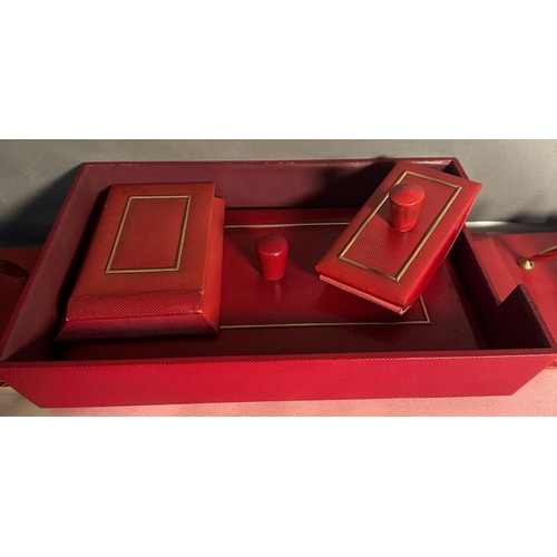 207 - A red leather desk top set comprising of a writing surface, blotters, document tray and storage pots