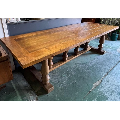 208 - A large oak farmhouse dining table with baluster legs (H77cm W280cm D100cm)