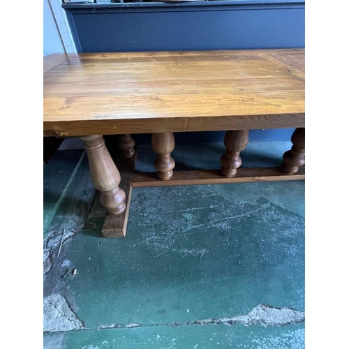 208 - A large oak farmhouse dining table with baluster legs (H77cm W280cm D100cm)