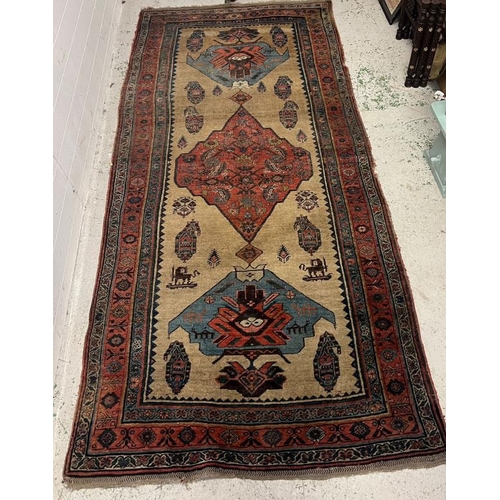 214 - Antique carpet/rug, three central medallions with a red boarder 294cm x 135cm