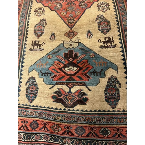 214 - Antique carpet/rug, three central medallions with a red boarder 294cm x 135cm