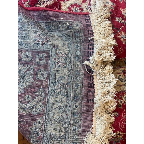 216 - A large red ground rug