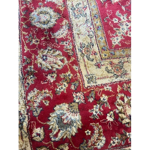 216 - A large red ground rug