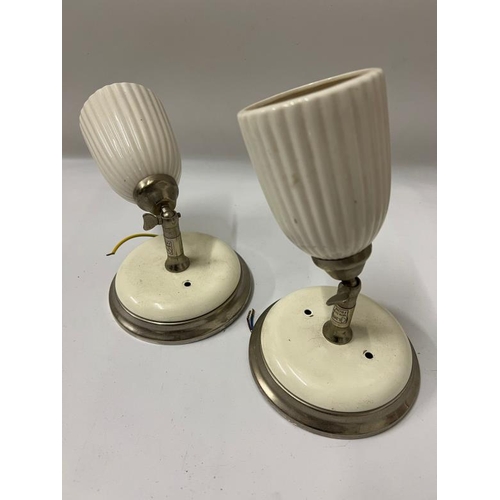 217 - A pair of ceramic cram spot lights with fluted shades and adjustable angles