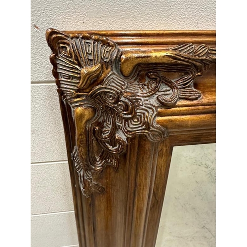 236 - A Baroque style copper effect over mantle mirror 87cm x 118cm