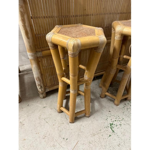 251 - A Mid century bamboo Tiki bar with three stools and a chair. The sheltered bar features a fringed ro... 