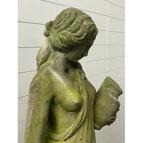 264 - A garden statue of a maiden on a raised plinth holding water jugs, reconstituted stone H126cm, plint... 