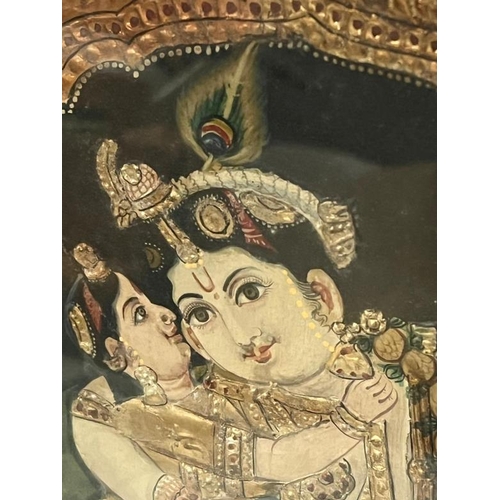 276 - An Indian painted and relief panel depicting Krishna with attendants under an ornate arch, possibly