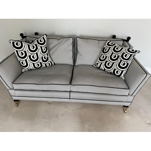 28 - A pair of Duresta two seater sofas in a black and white flecked upholstery and piped in black