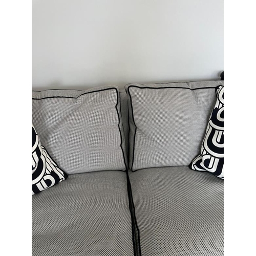 28 - A pair of Duresta two seater sofas in a black and white flecked upholstery and piped in black