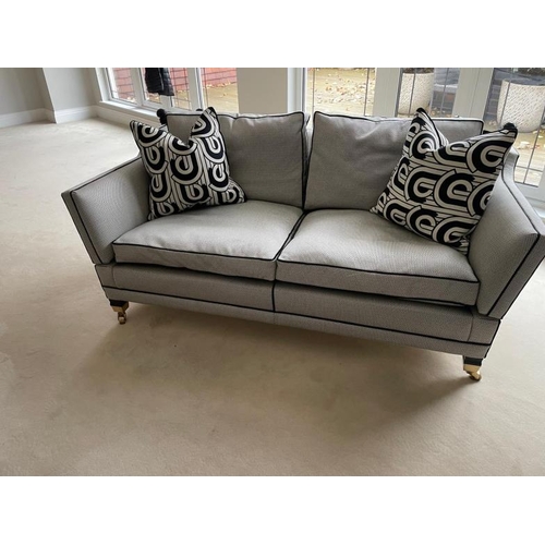 28 - A pair of Duresta two seater sofas in a black and white flecked upholstery and piped in black