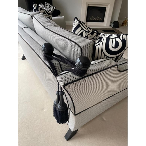 28 - A pair of Duresta two seater sofas in a black and white flecked upholstery and piped in black