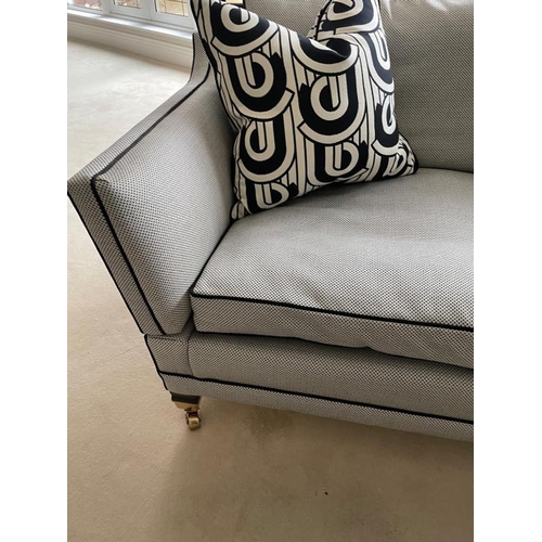 28 - A pair of Duresta two seater sofas in a black and white flecked upholstery and piped in black