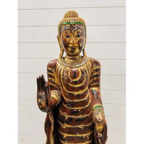 283 - A large standing Buddha in the peace pose, wooden sculpture on square base (H165cm W40cm)