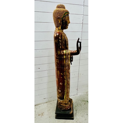 283 - A large standing Buddha in the peace pose, wooden sculpture on square base (H165cm W40cm)