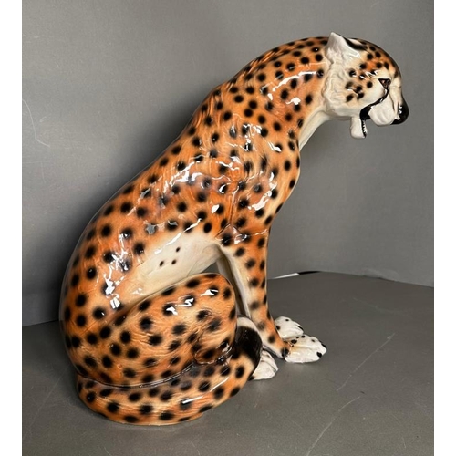 310 - A seated ceramic Cheetah with repairs to legs H43cm