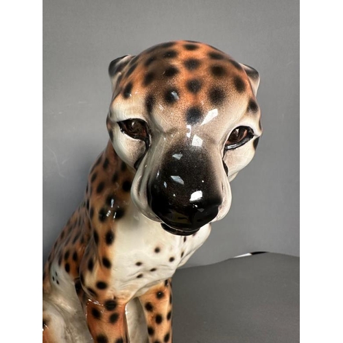 310 - A seated ceramic Cheetah with repairs to legs H43cm