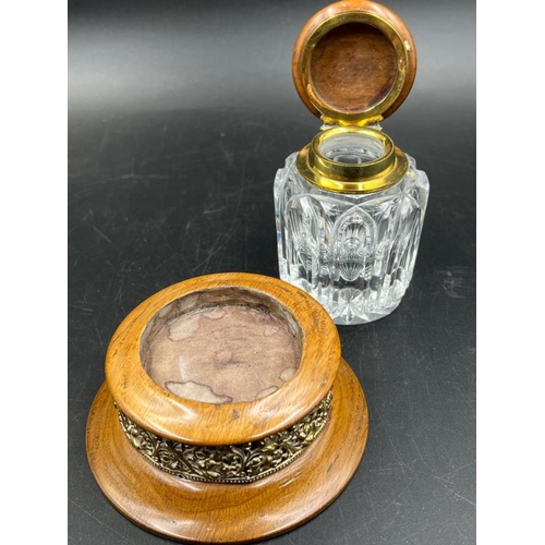 355 - An antique cut glass inkwell with brass fitments on wooden stand. 12.5cm H