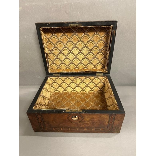 379 - A walnut sewing box with mother of pearl central shield and inlay to border