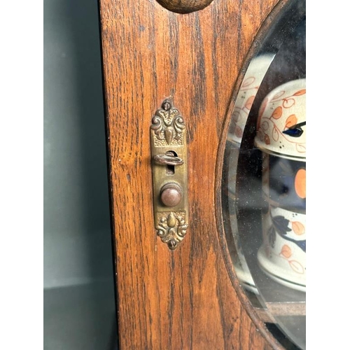 385 - A Victorian carved oak smokers cabinet, bevel glazed and complete with ceramic tobacco jar and clay ... 