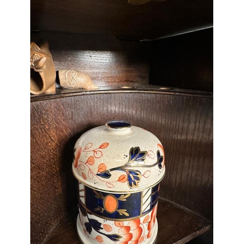 385 - A Victorian carved oak smokers cabinet, bevel glazed and complete with ceramic tobacco jar and clay ... 