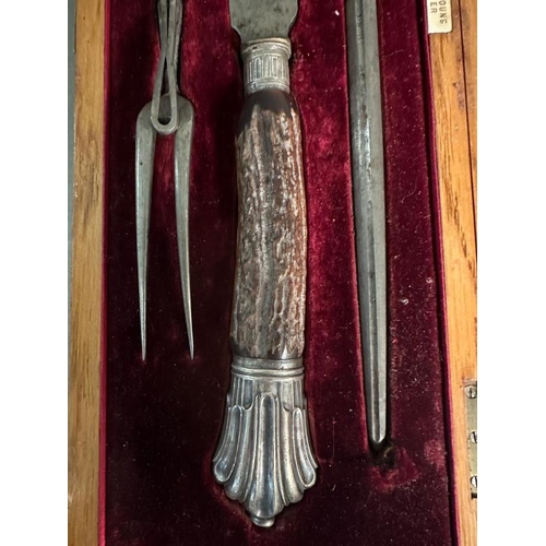 406 - A horn handled carving set with silver heels and collars, hallmarked for Sheffield 1907 by Depree Ra... 