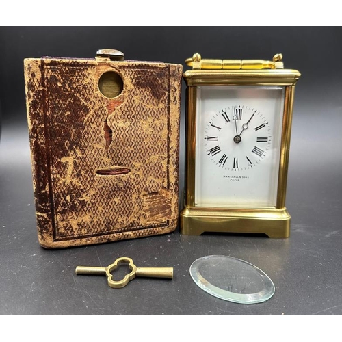 425 - An antique French Margaine carriage clock in leather travel case (Glass to top and handle need fixin... 