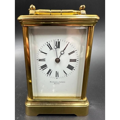 425 - An antique French Margaine carriage clock in leather travel case (Glass to top and handle need fixin... 