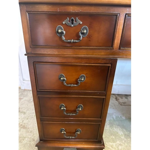 43 - A brown leather topped pedestal desk, central long drawer flanked by four shorter (H76cm W120cm D60c... 