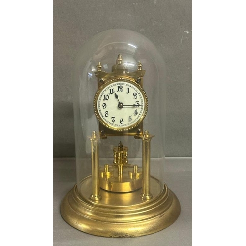 431 - A continental 19th Century brass Torsion clock with enamel face and glass dome