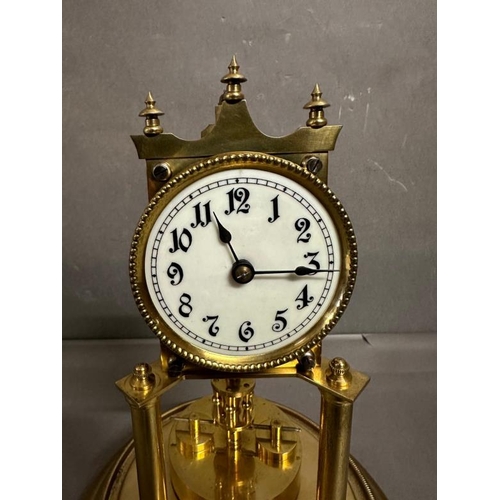 431 - A continental 19th Century brass Torsion clock with enamel face and glass dome