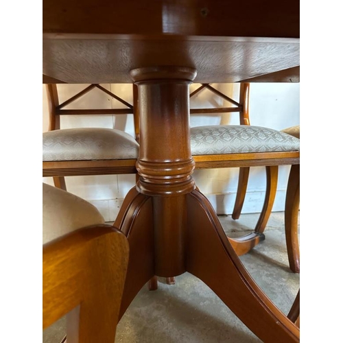 44 - A Bradley veneered extendable pedestal dining table on brass lions paw feet and seven chairs (H76cm ... 