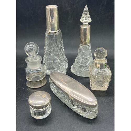 456 - A selection of twelve dressing table / scent bottles with hallmarked silver fittings.