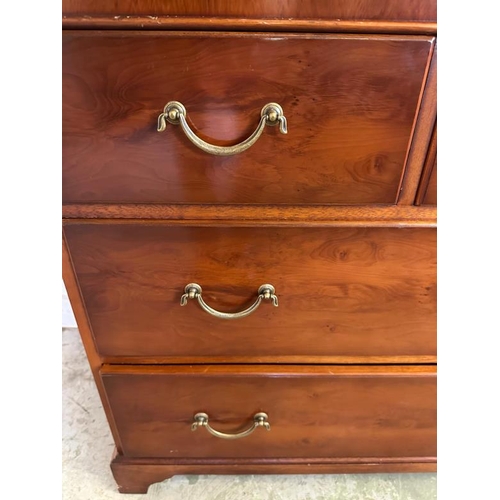 47 - A mahogany veneer sideboard with a bevel edged mirror over and multiple long and short drawer under ... 