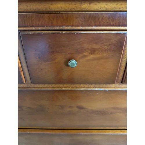 47 - A mahogany veneer sideboard with a bevel edged mirror over and multiple long and short drawer under ... 